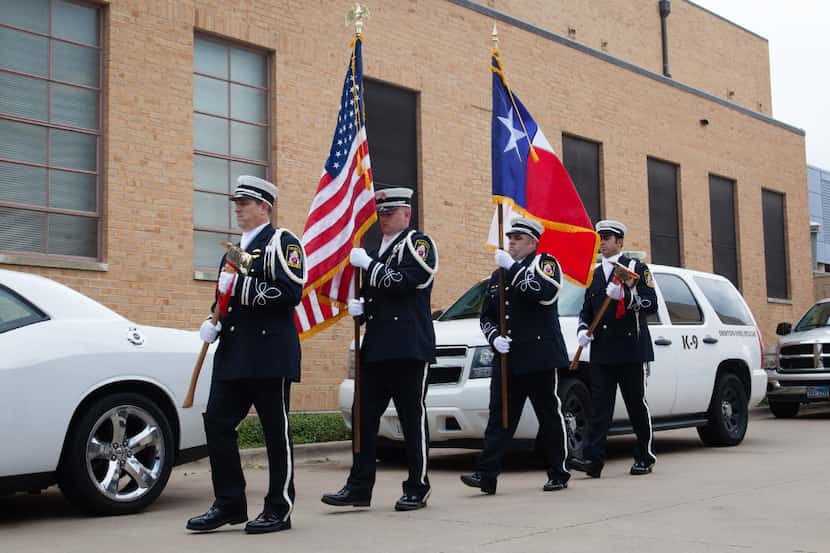 The Denton Honor Guard carries the flags out to the podium before a speech during the Public...