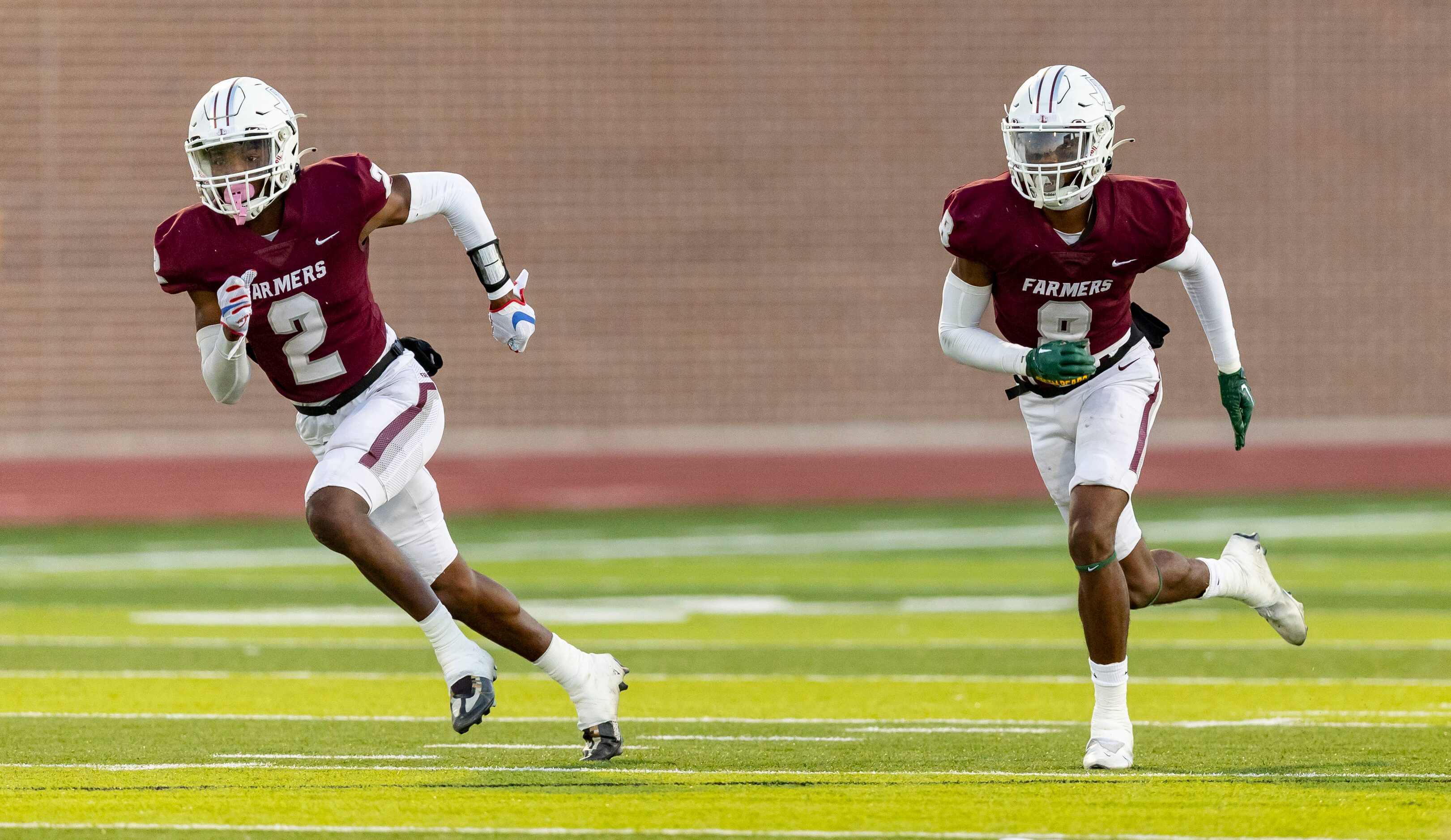 Brothers and Lewisville senior defensive backs Cameren (2) and Caden Jenkins (8) defend on a...