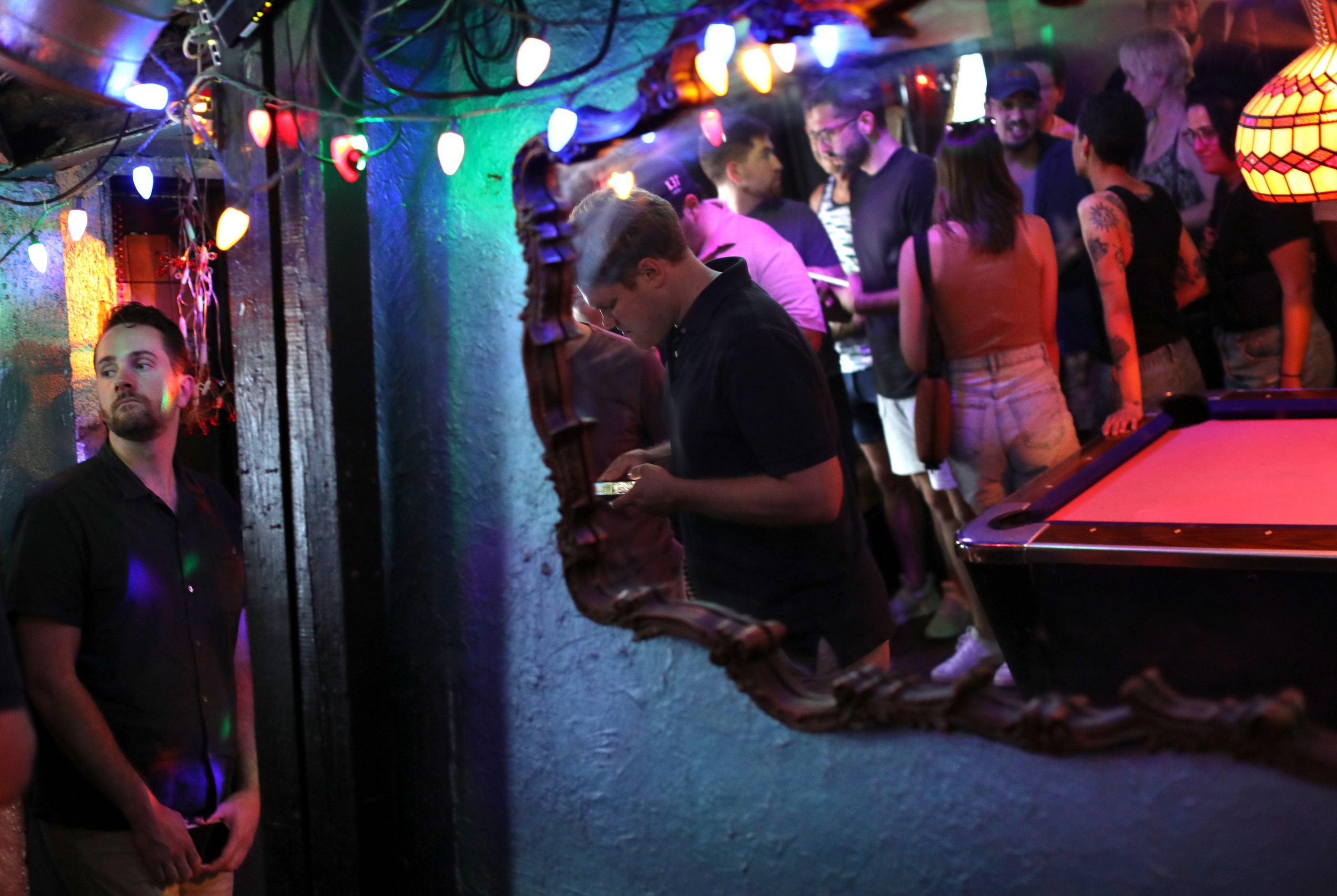 Guests wait in line for the bar as they enjoy one last evening at the Grapevine Bar in...