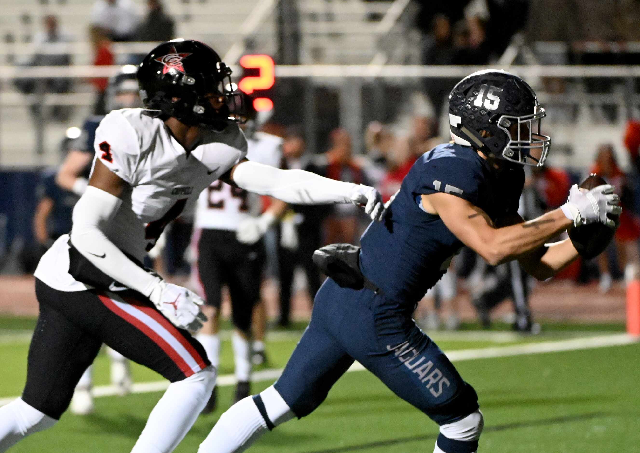 Flower Mound's Walker Mulkey (15) catches a touchdown pass in front of Coppell's Braxton...
