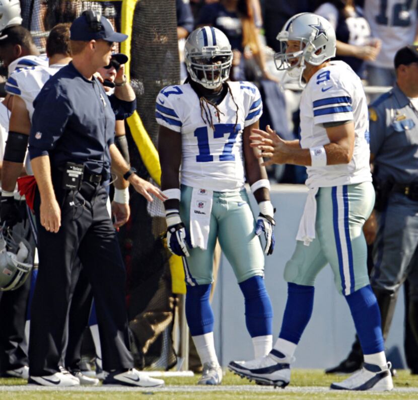 Dallas Cowboys quarterback Tony Romo (9) talks with head coach Jason Garrett after a forced...