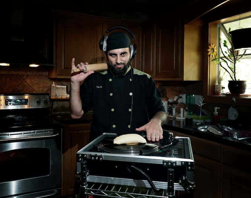 Local Chef and Hip Hop DJ Julio Cordonnier poses with his turn table and an empanada at his...