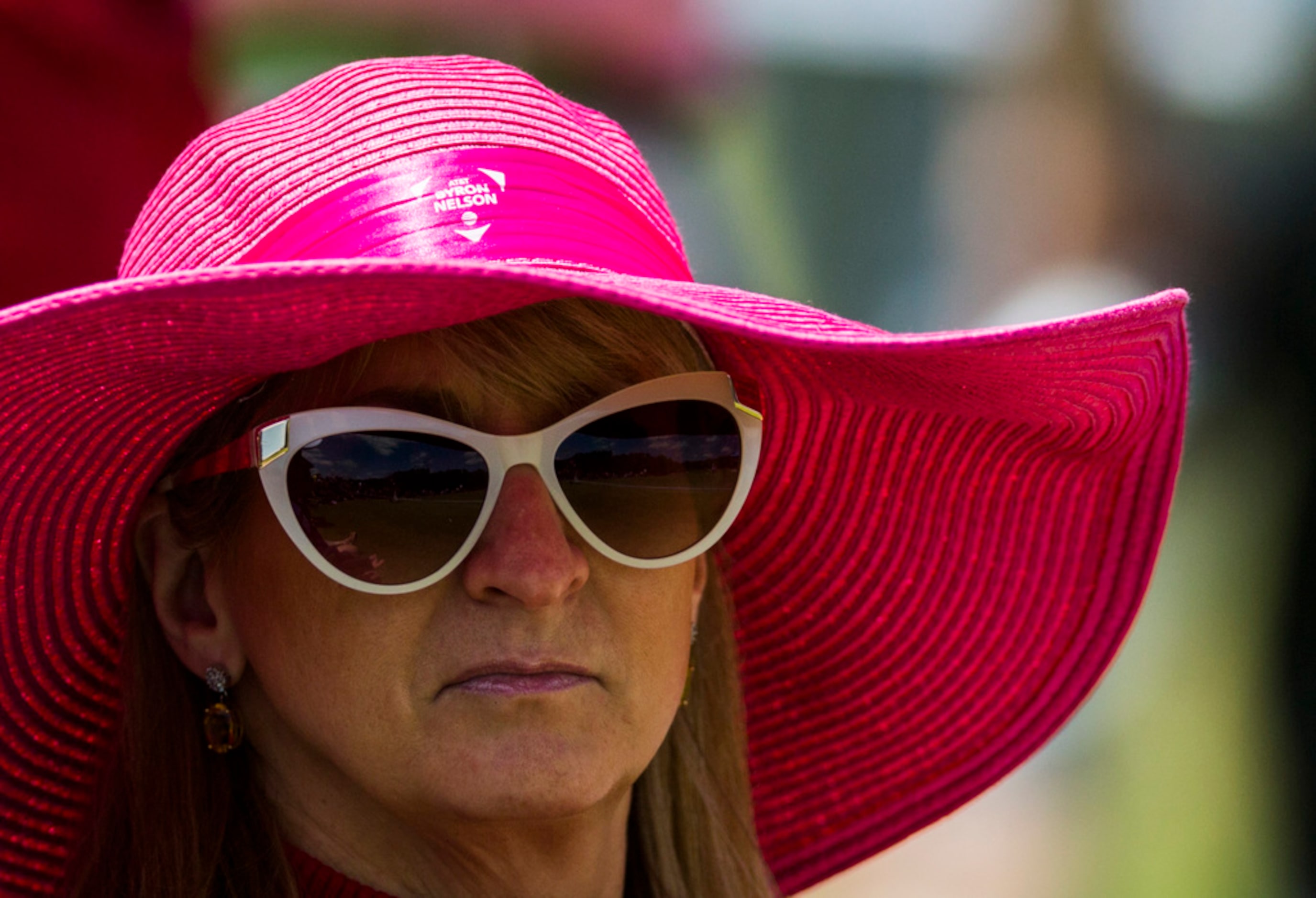 A woman wears a pink Byron Nelson Mothers' Day hat that was given to fans during round 4 of...