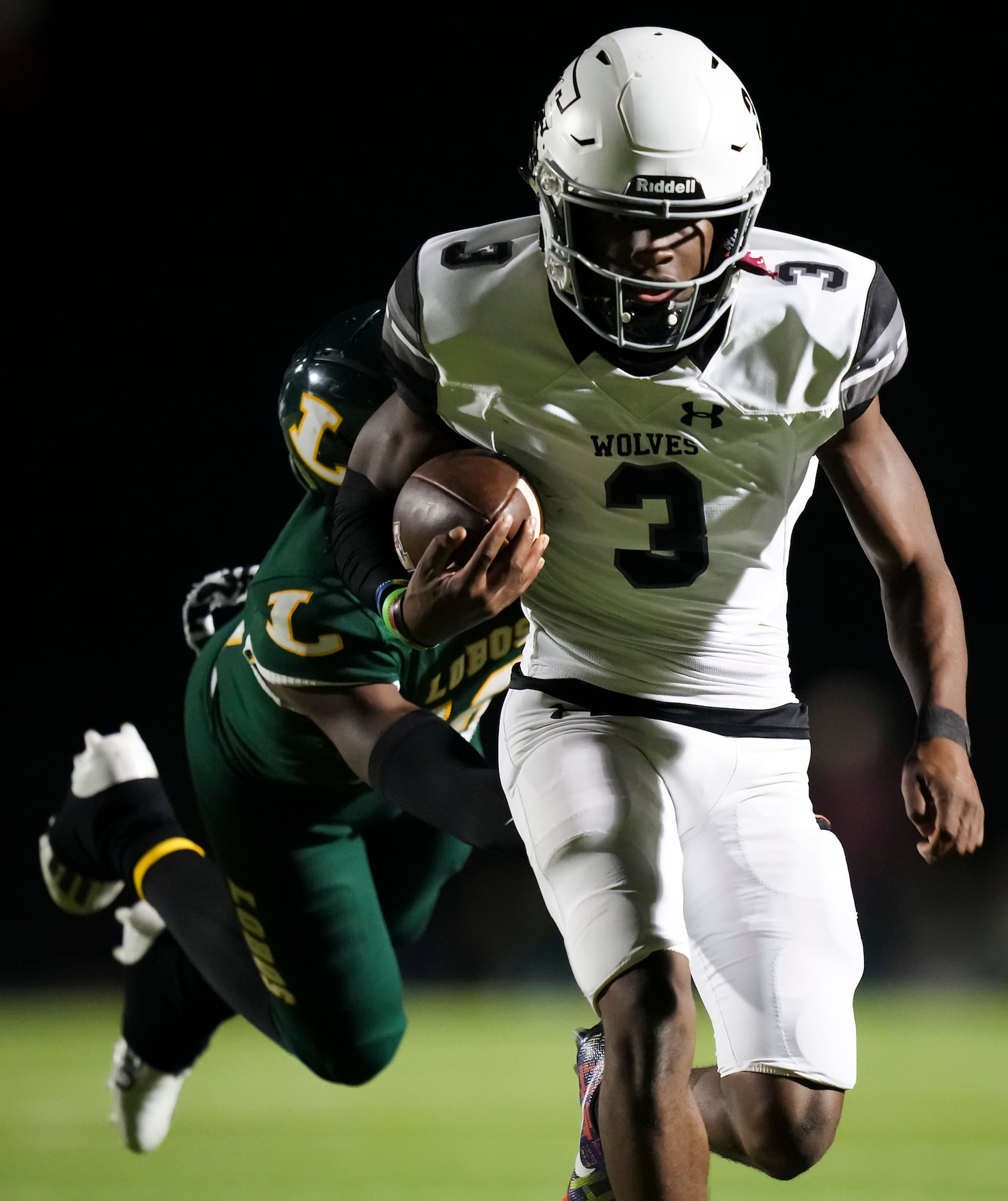 Mansfield Timberview quarterback Cameron Bates (3) gets past Longview defensive back...