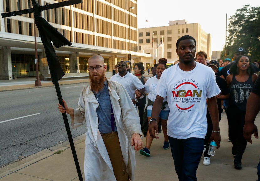 The Rev. Dr. Jeff Hood, left, and Dominique Alexander lead protestors east on Commerce St...