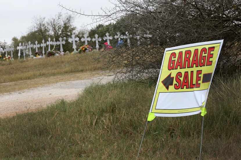 A sign for a garage sale stands outside the Ward residence on 13th Street in Sutherland...