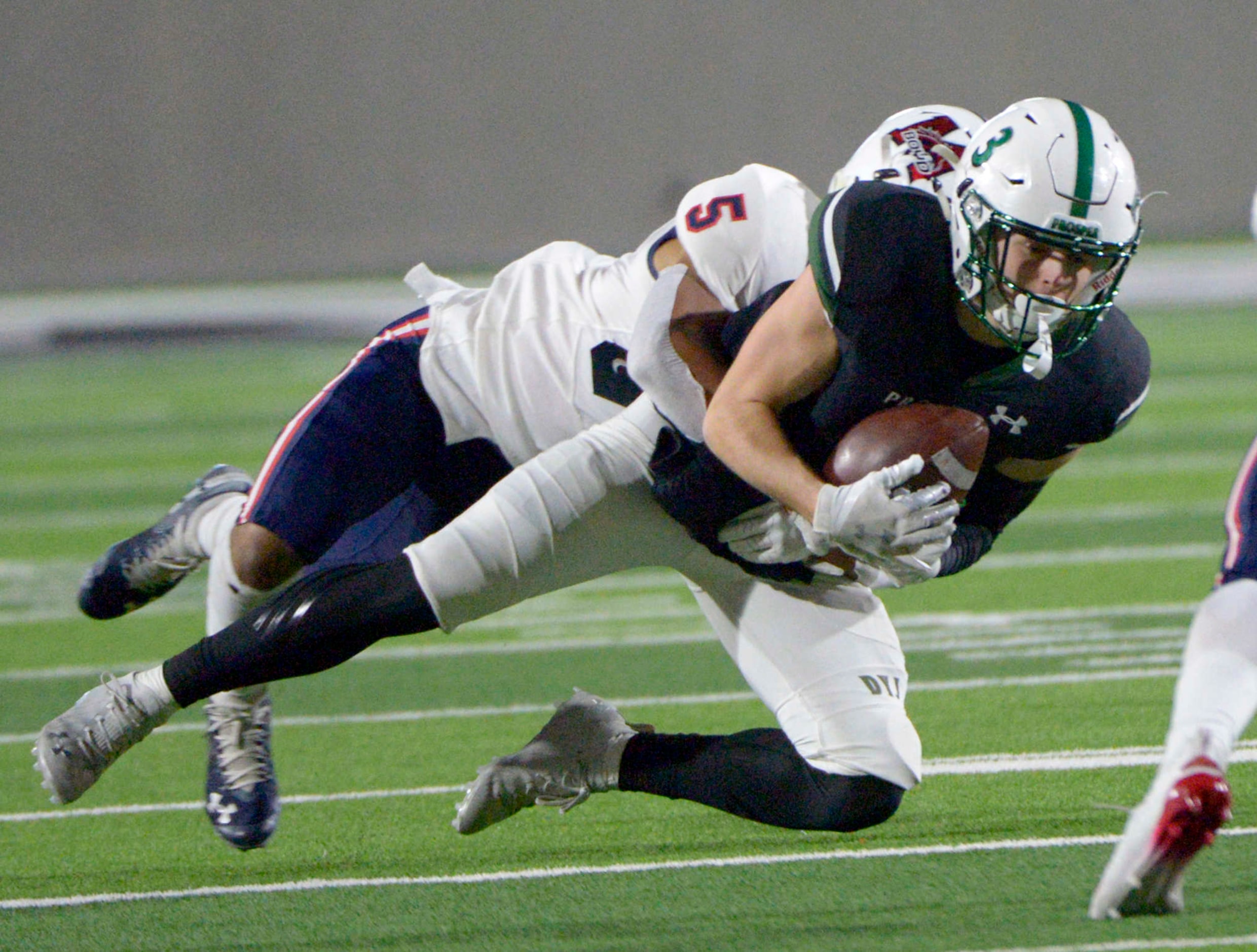 Prosper’s Keaton Nickerson (3) catches a pass in front of McKinney Boyd’s Evan Dennis (5) in...