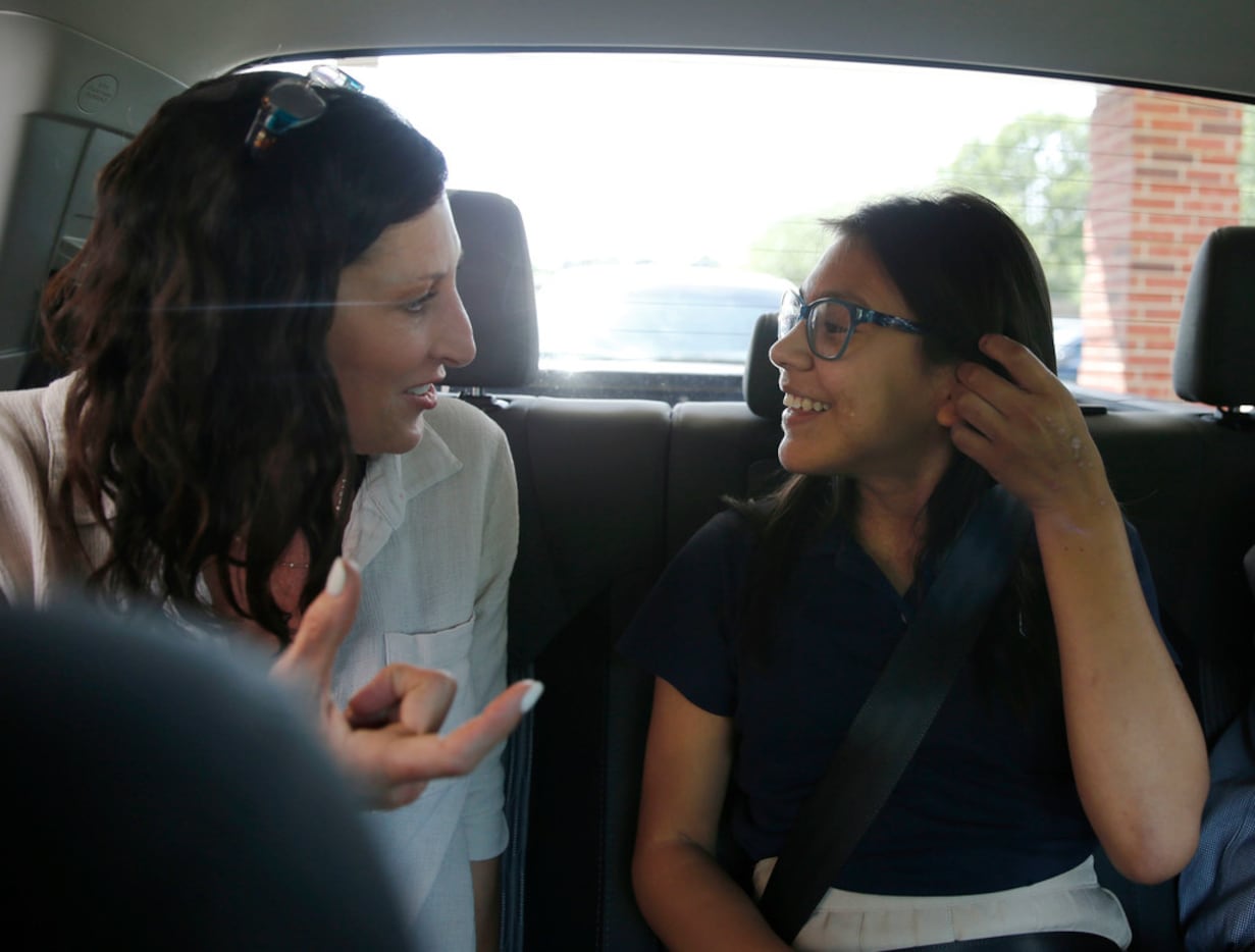 Katie Ballard and her 12-year-old adoptive daughter, Emi, share a laugh on the drive home...