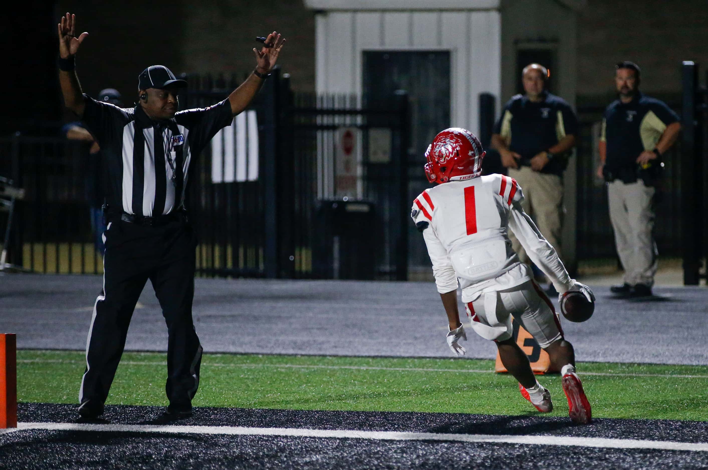 Terrell junior Kanye Nix (1) scores a touchdown during the first half of a high school...
