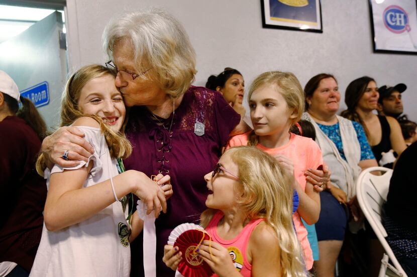 Allyson Garmon, 11, (left) is kissed by her grandmother Peggy Garmon, with Allyson's sisters...