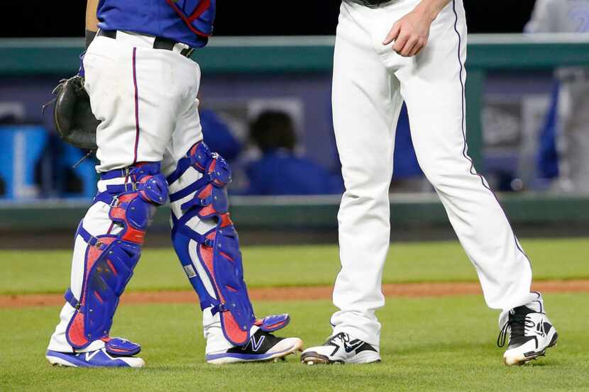 Texas Rangers relief pitcher Jake Diekman, right, and catcher Juan Centeno celebrate a 5-1...