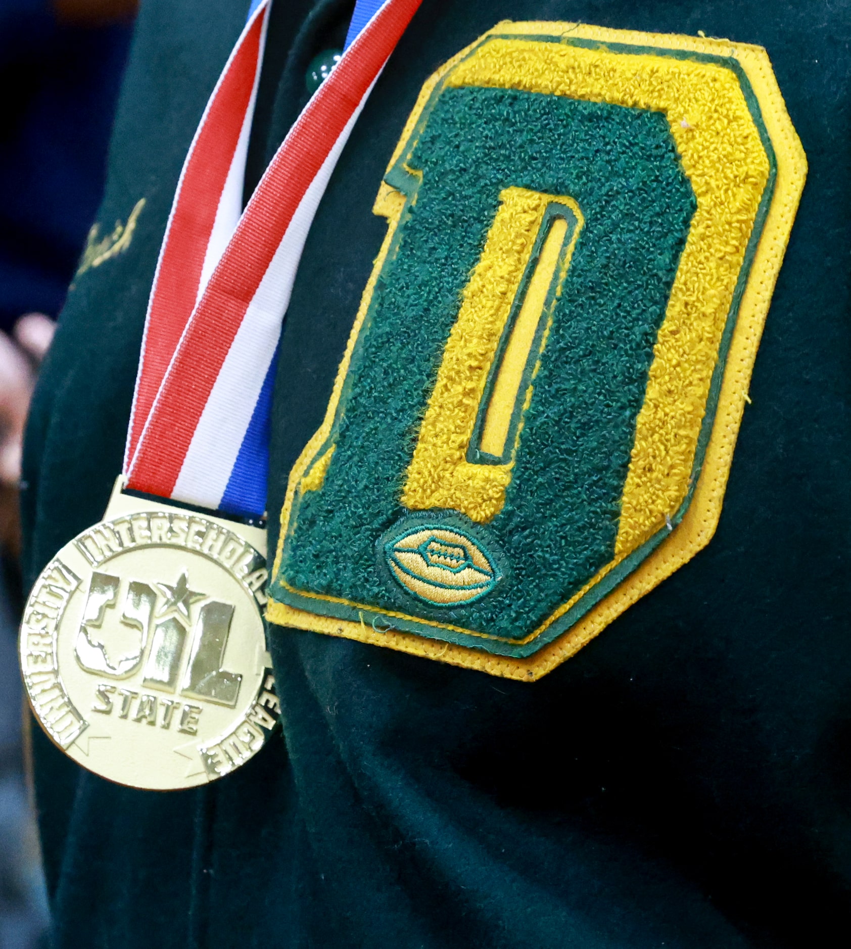 A DeSoto High School football player wears his State Championship medal, Saturday, Jan. 21,...