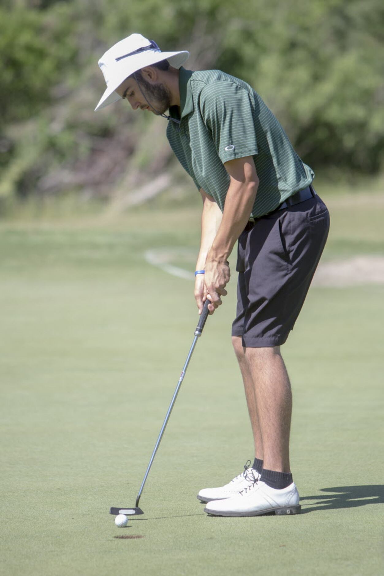 Southlake Carroll junior Trent Hill makes a putt on the fifth green during the UIL 5A State...