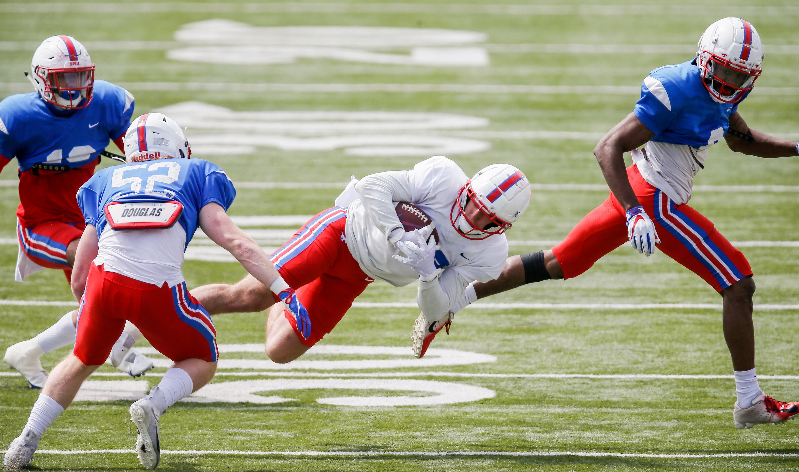 SMU defensive lineman Junior Aho (33) carries the ball during practice at Gerald Ford...