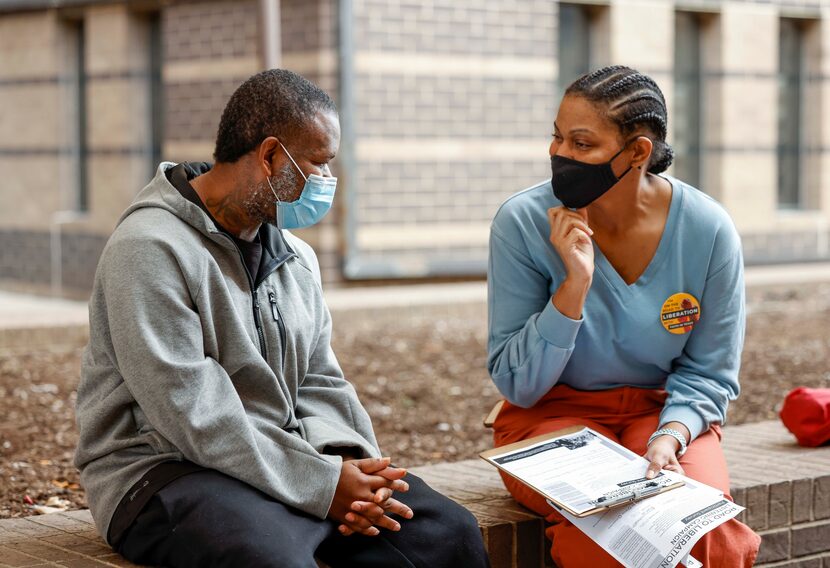 Rev. Rebecca Davis (right) speaks with Robin Wilks after he was released from the Lew...