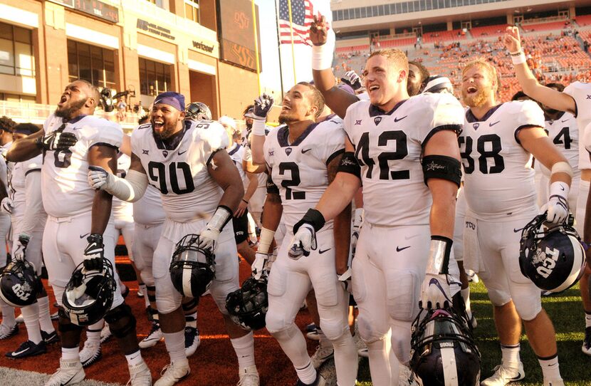 TCU players celebrate with their fans in the end zone of Boone Pickens Stadium in...