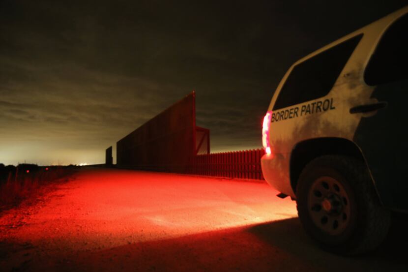 A U.S. Border Patrol vehicle stops near a section of the Texas- Mexico border fence in La...