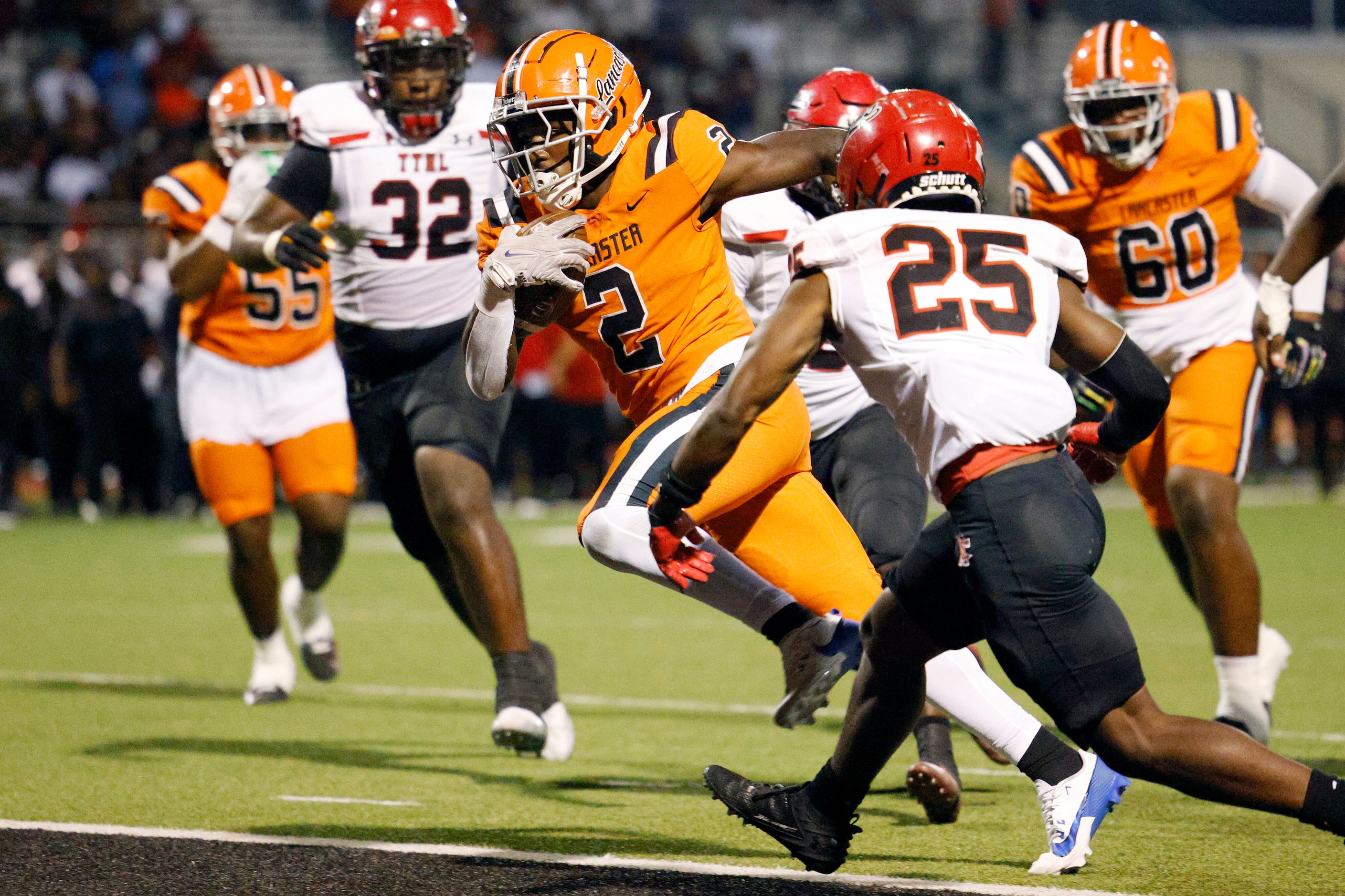 Lancaster running back Izayah Lee (2) runs past Cedar Hill defensive back Johnnie Miles (25)...