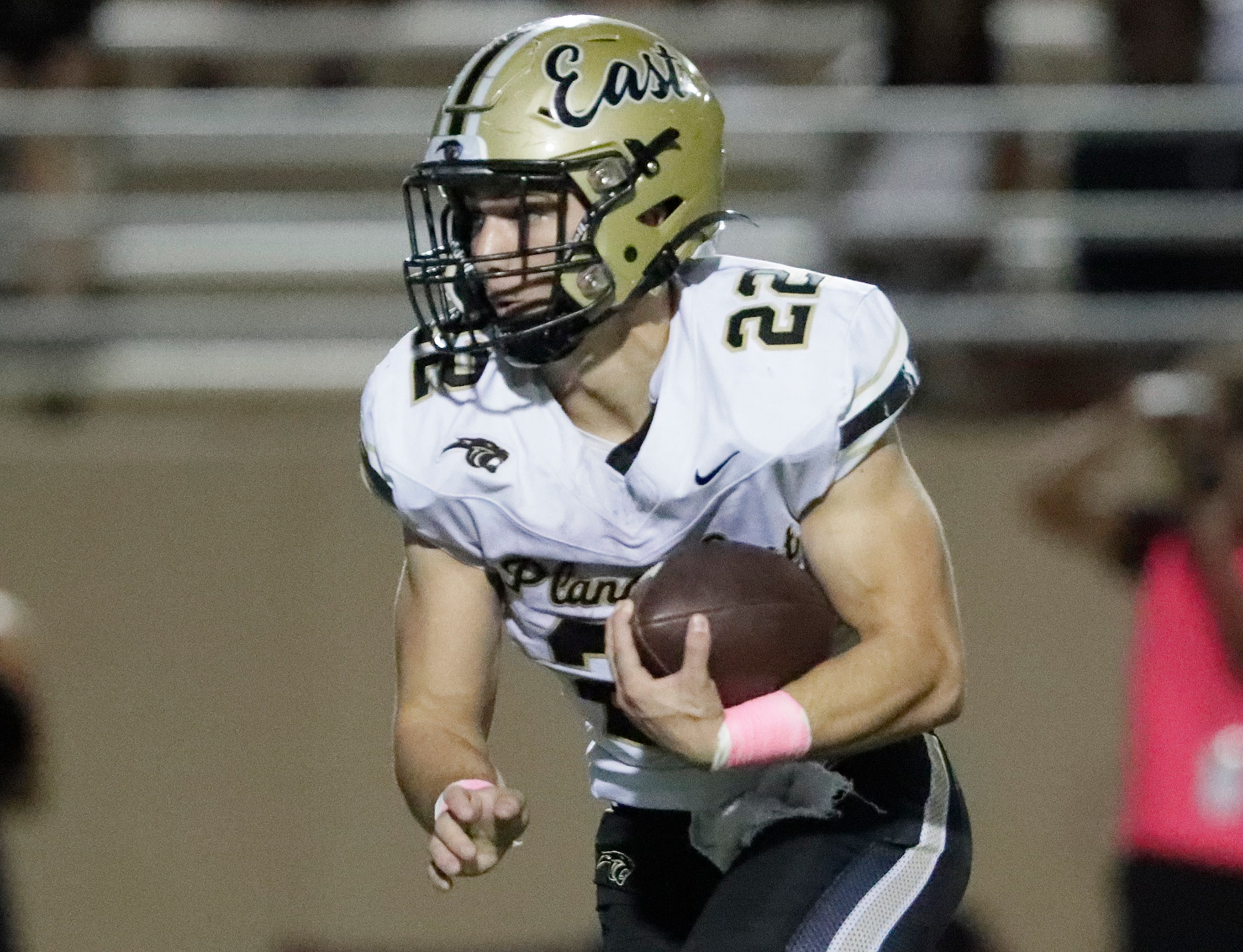 Plano East High School running back Travis Agee (22) runs the ball during the first half as...