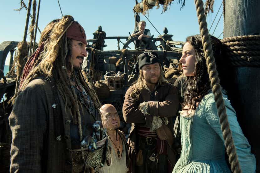 In this image released by Disney, Johnny Depp portrays Jack Sparrow, left, and Kaya...