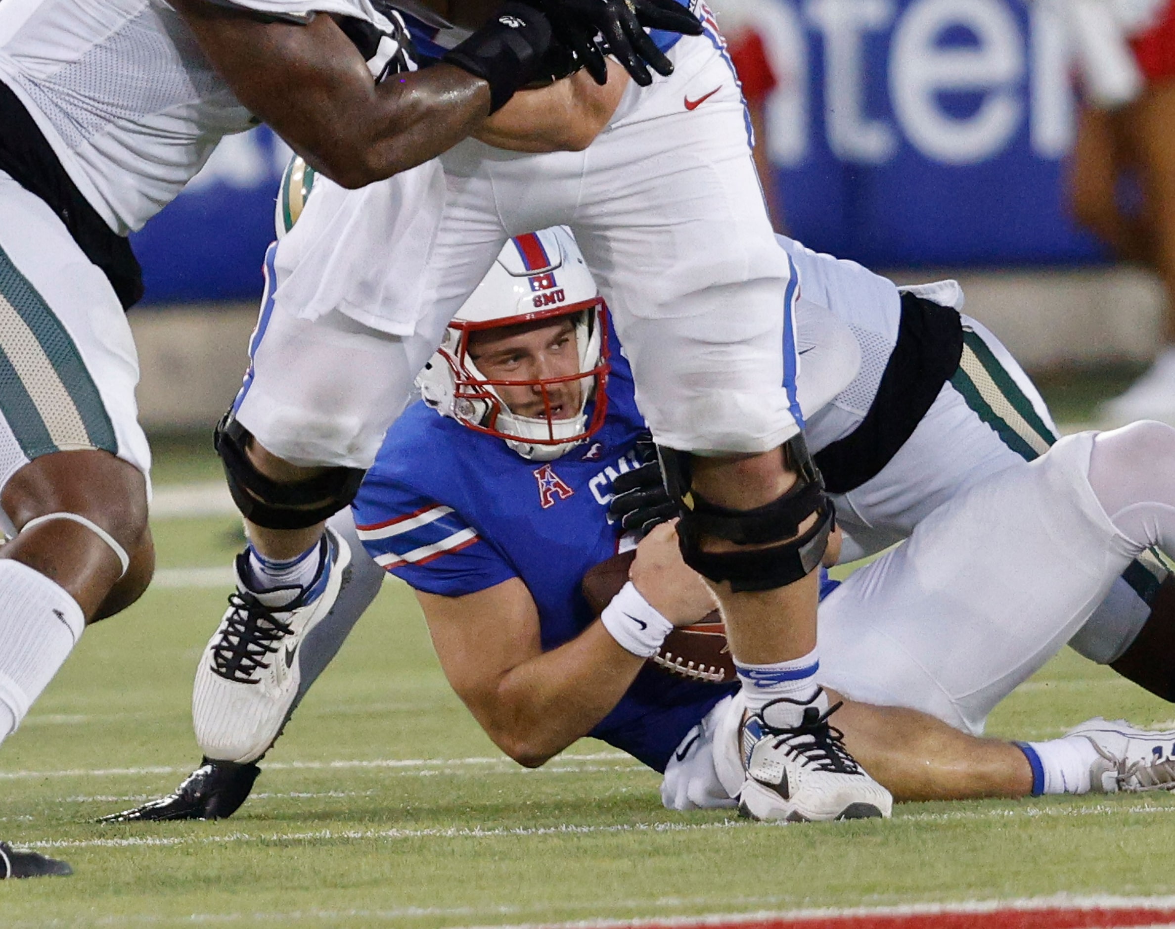 SMU quarterback Preston Stone (2) is tackled by Charlotte 49ers linebacker Stone Handy (11)...