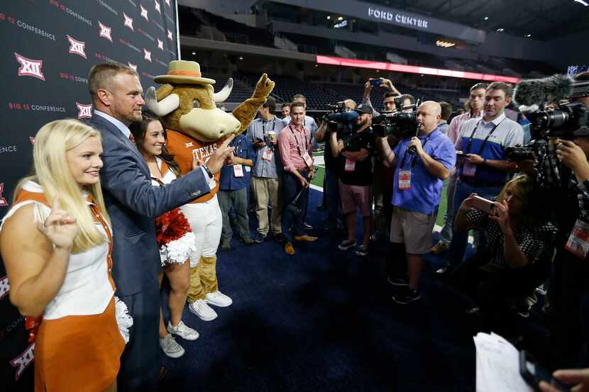 Texas head football coach Tom Herman, second from left, poses for a photograph with...