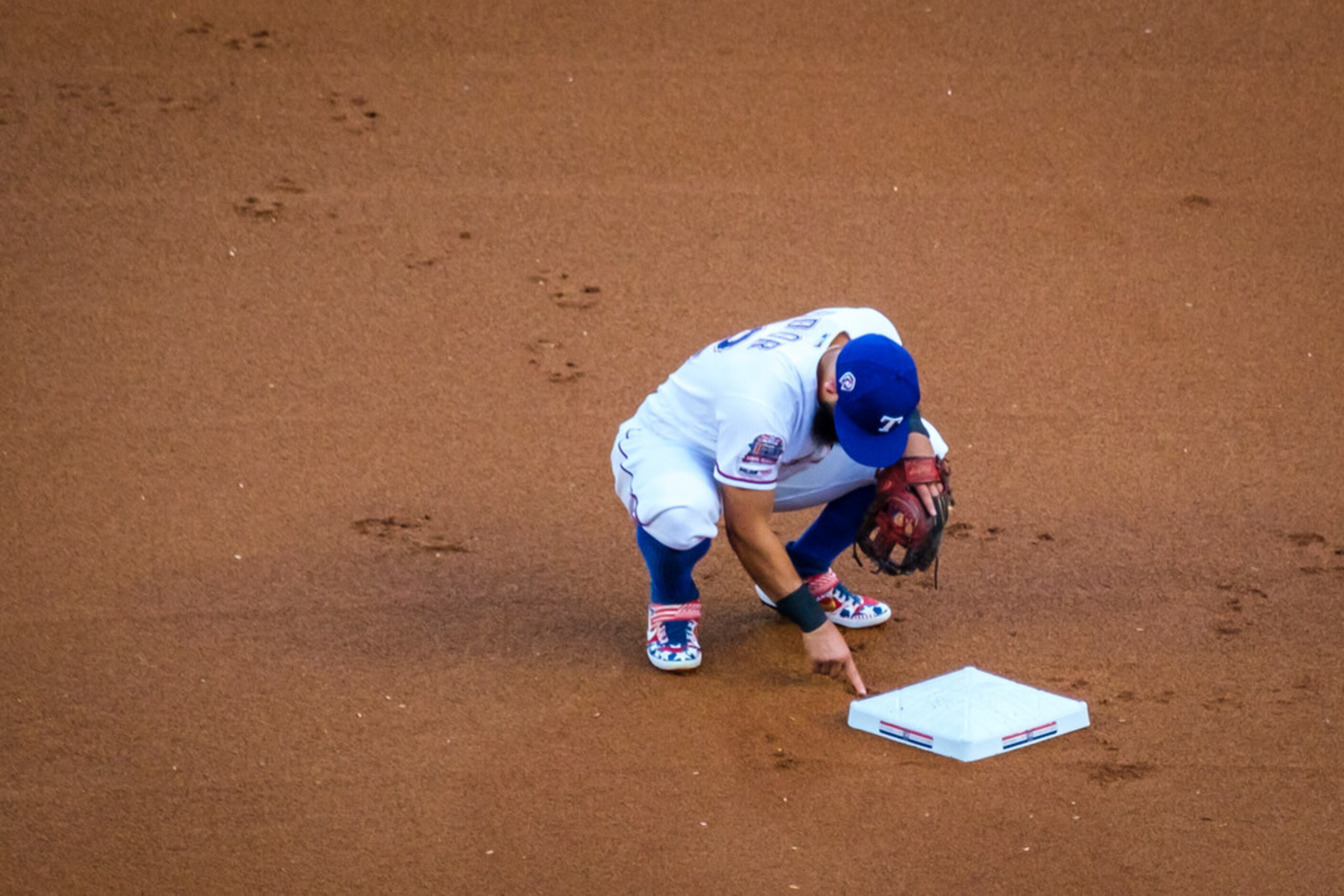 Texas Rangers second baseman Rougned Odor makes the dirt byehind second base before a game...