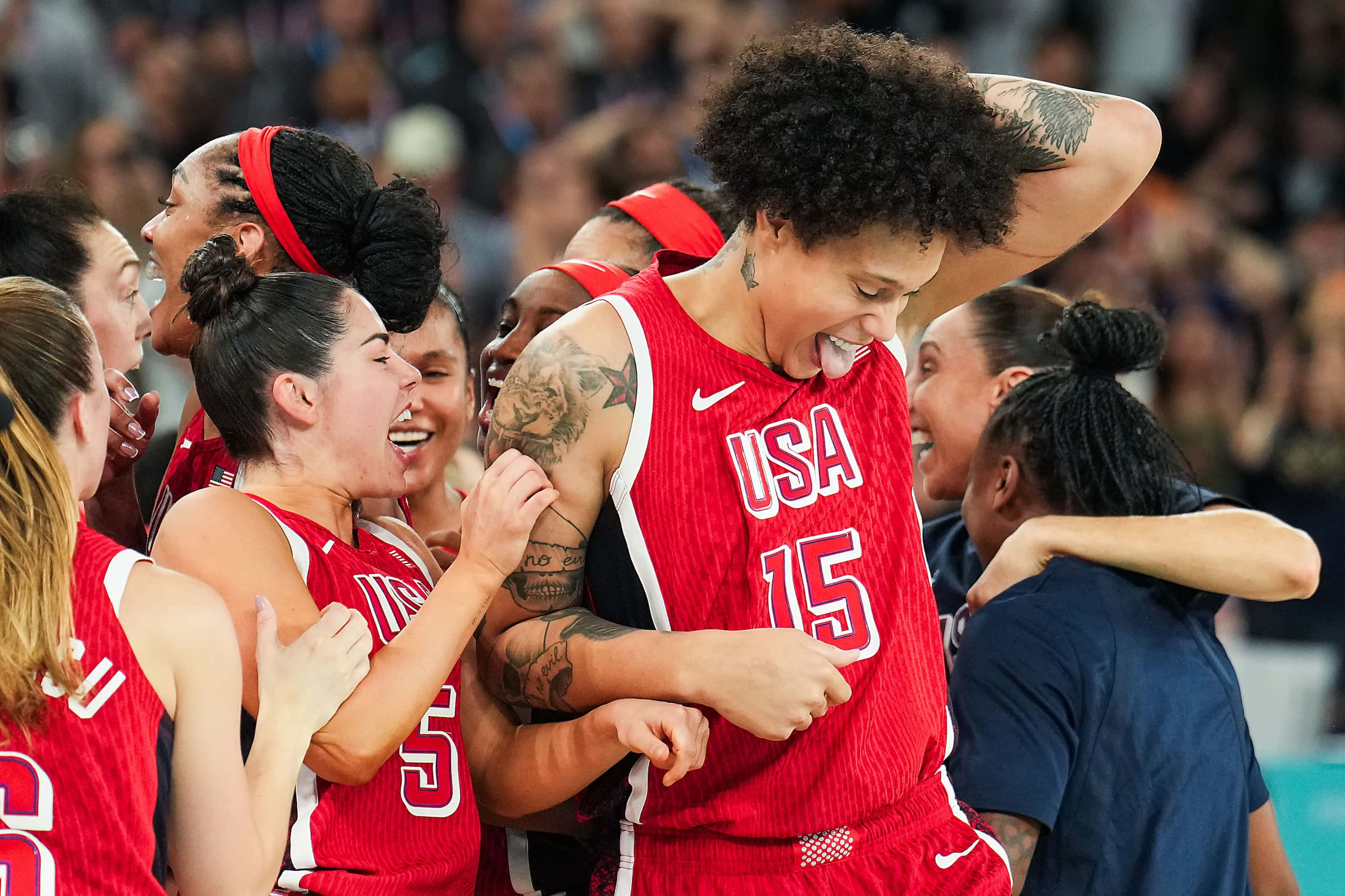 Brittney Griner (15) of the United States celebrates with Kelsey Plum (5) after a victory...