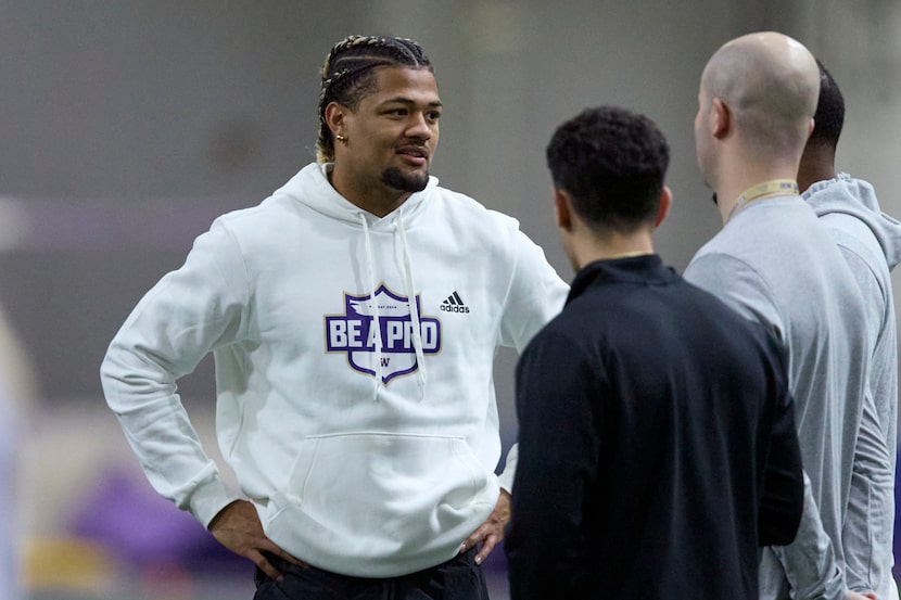 Washington wide receiver Rome Odunze talks while standing on the field during Washington's...