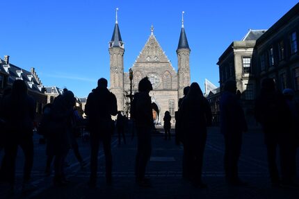 People wait in line to vote during the Dutch general elections in The Hague on March 15,...