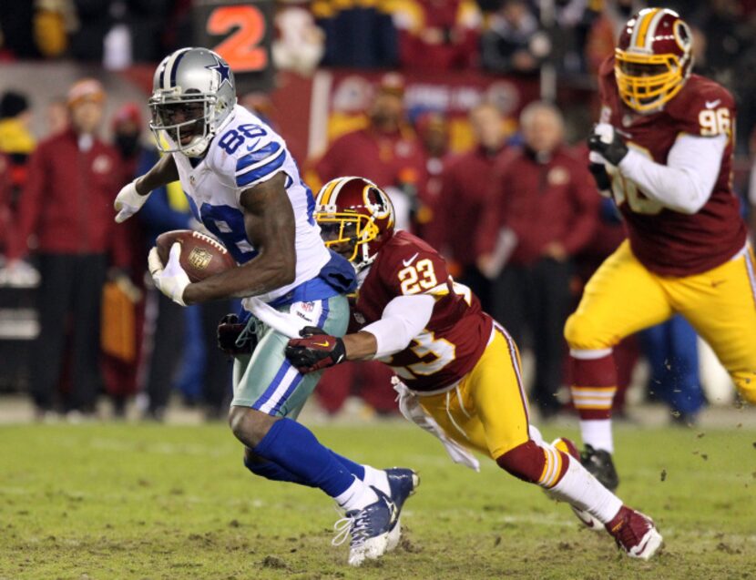 Dallas Cowboys wide receiver Dez Bryant (88) is tackled by Washington Redskins cornerback...