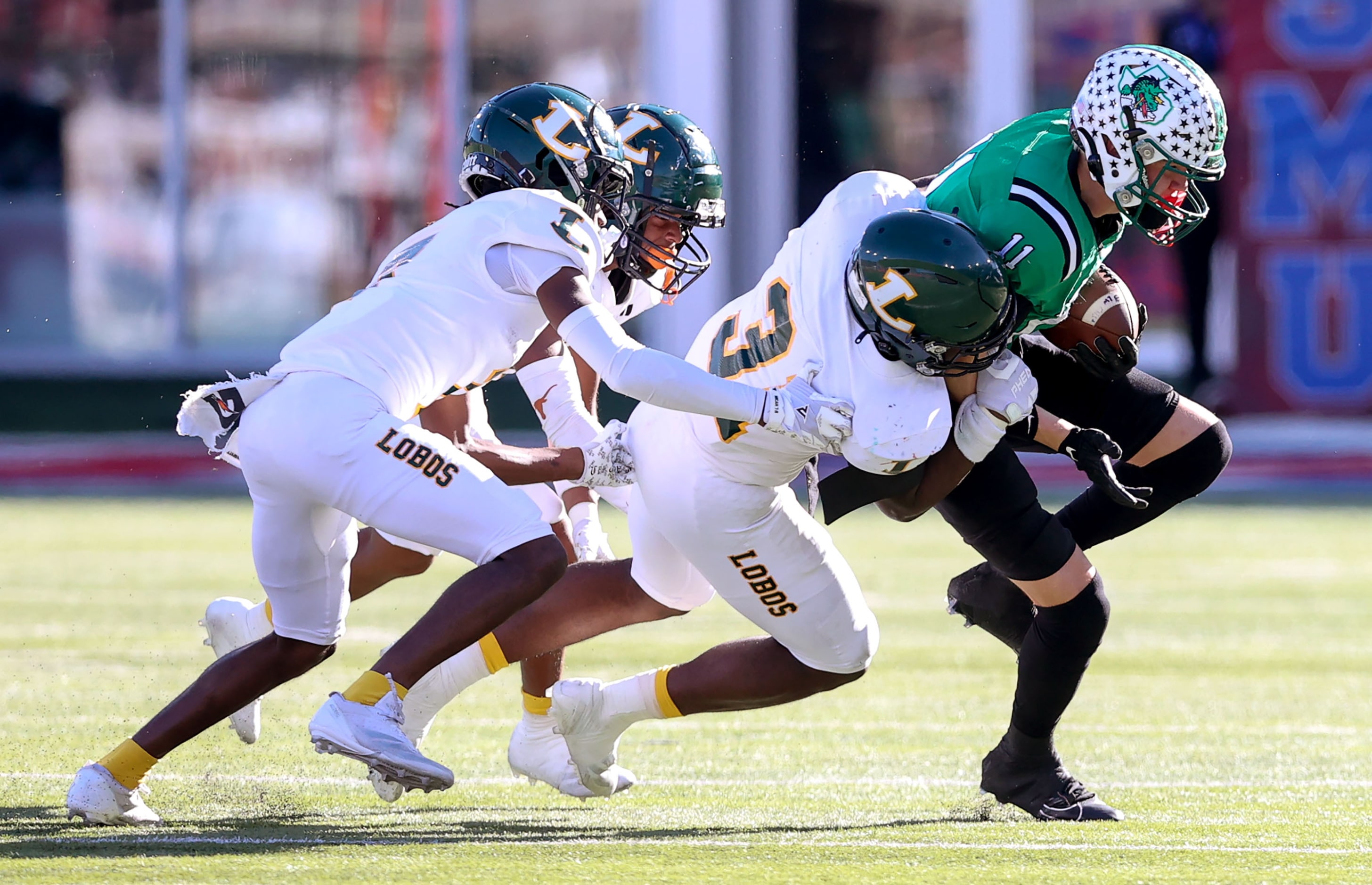 Southlake Carroll wide receiver Brock Boyd (11) gets dragged down by Longview linebacker...