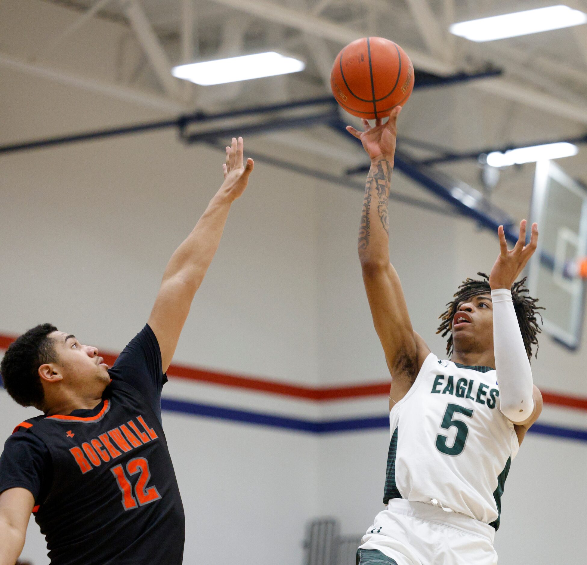 Mansfield Lake Ridge's Ahmare Rose (5) floats a shot over Rockwall's Torin Cantu (12) during...