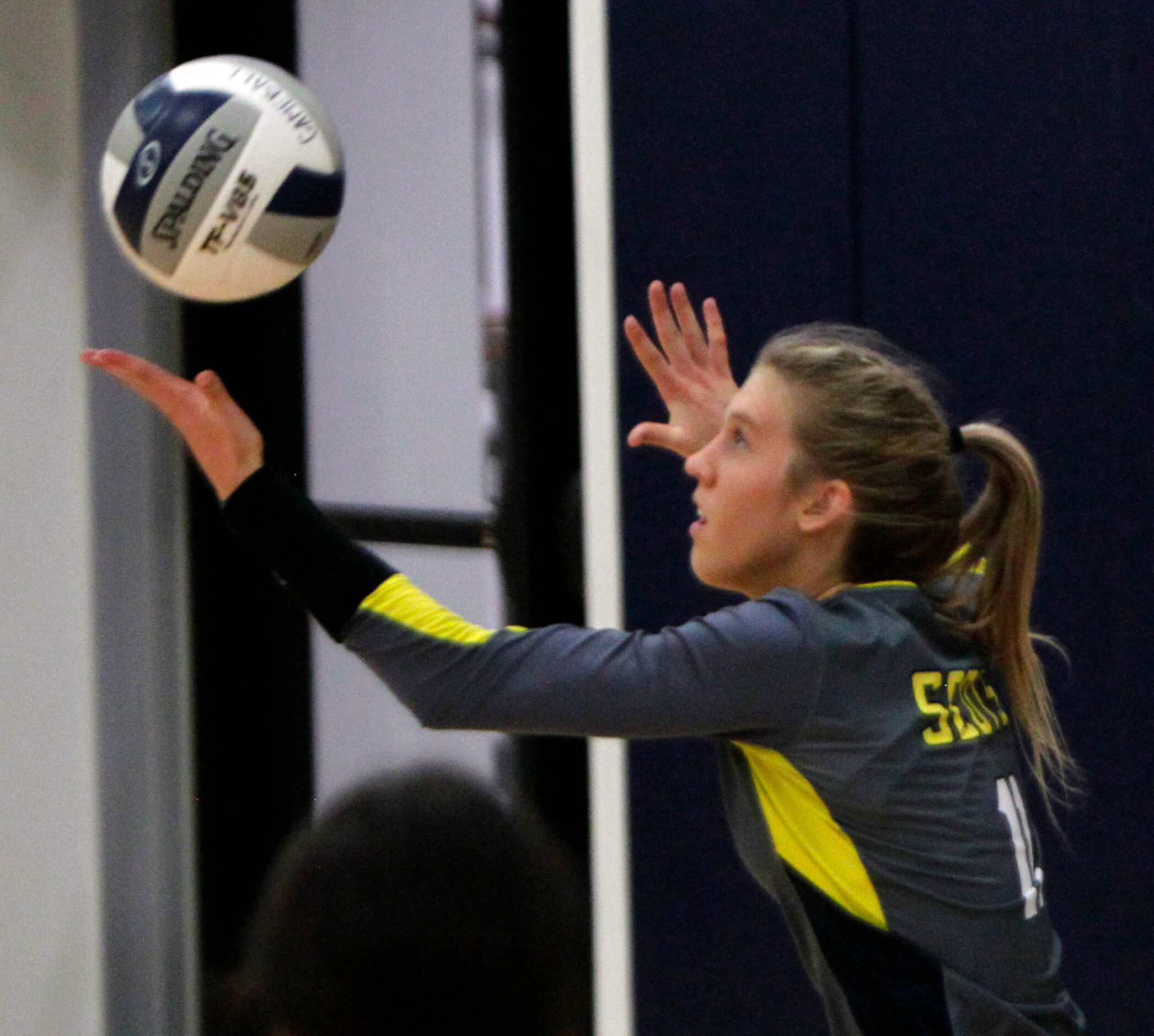 Highland Park's Sydney Breon (11) prepares to serve during the 3rd set of their match...