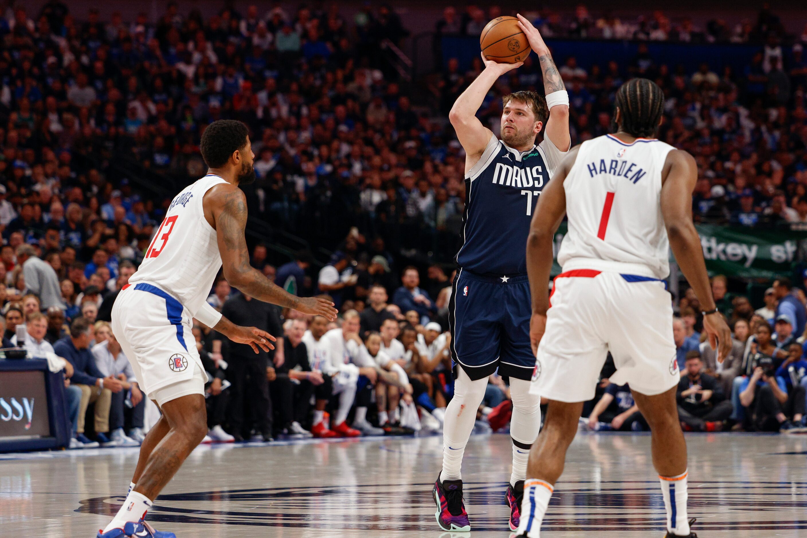 Dallas Mavericks guard Luka Doncic (77) shoots over LA Clippers forward Paul George (13)...