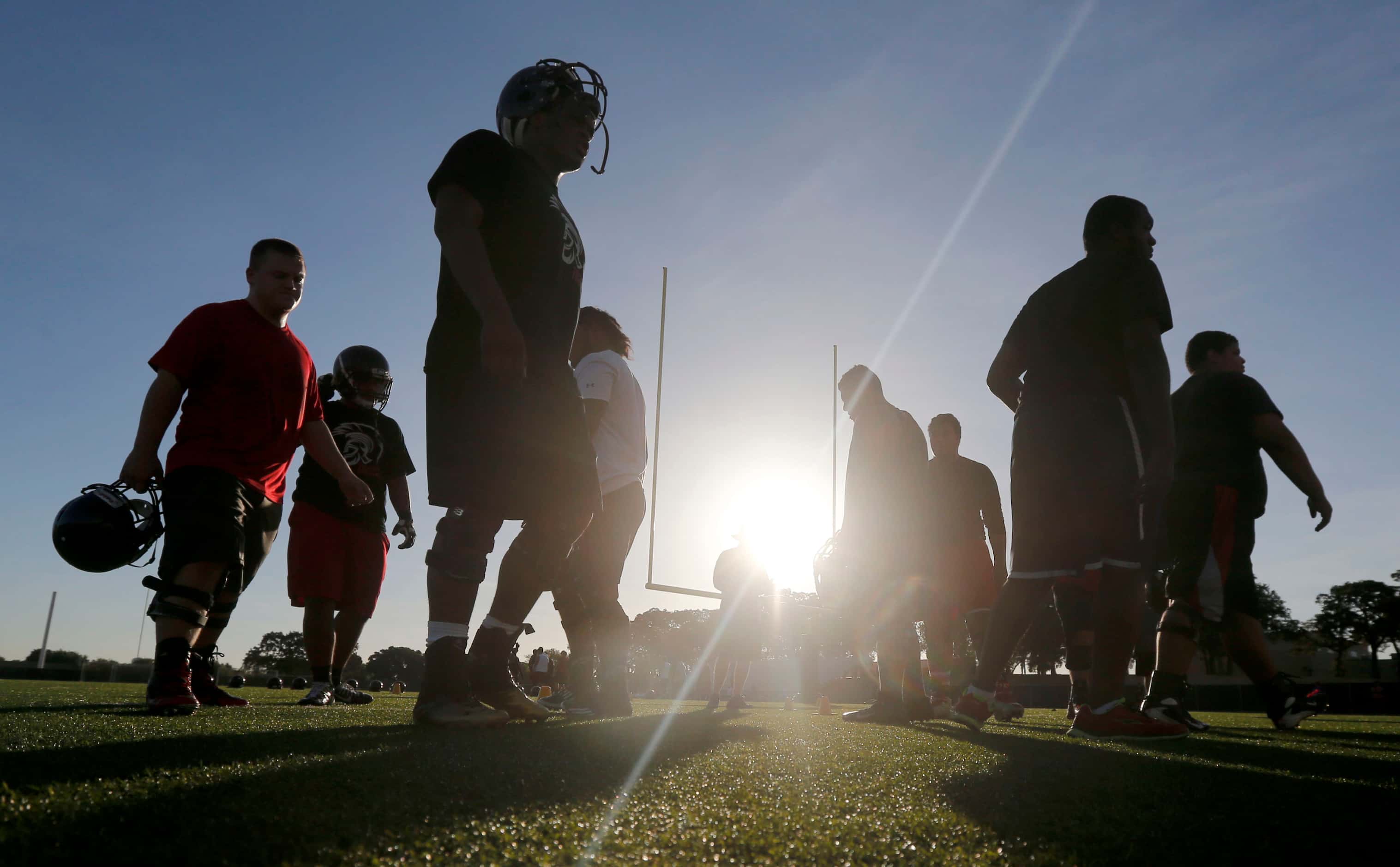 Players prepare during Euless Trinity's first day of football practice at the high school in...