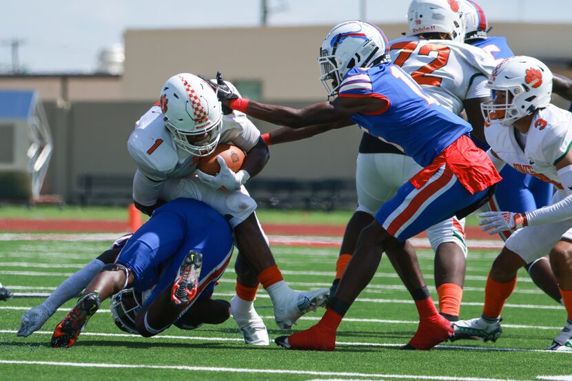 Duncanville High School Kadavion Dotson-Walker (2) rolls into Jones High School Jerrian...