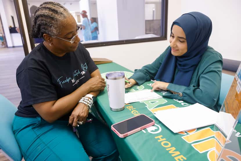Rosalind Rayford, left, is read her health screening results by Dr. Samiha Khan with ICNA...