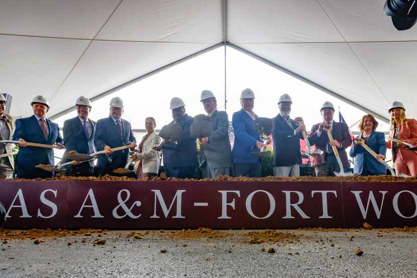 Texas A&M University System, Fort Worth and business leaders toss dirt at a groundbreaking...