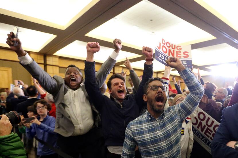 Supporters of Democratic candidate for U.S. Senate Doug Jones react during an election-night...