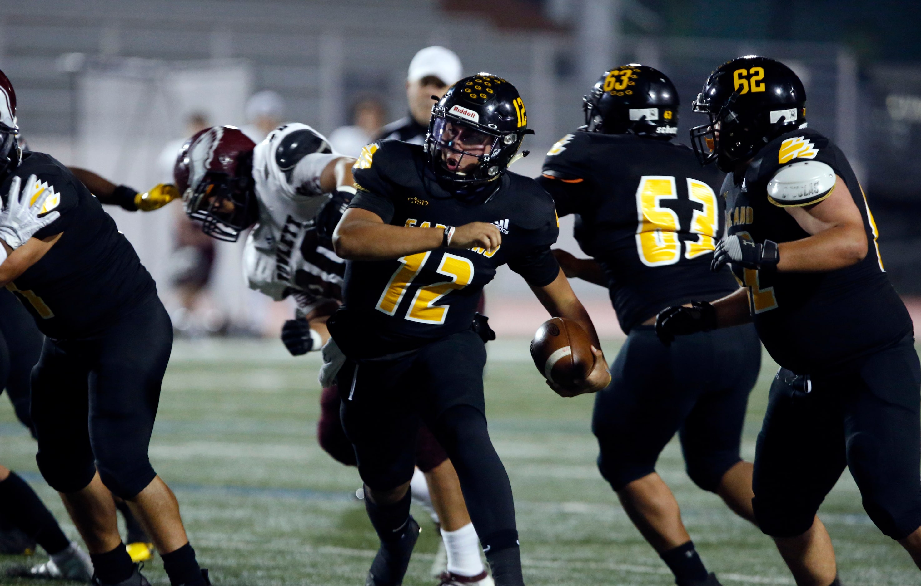 Garland’ QB Sergio Perez (12) runs for a touchdown during the first half of high school...