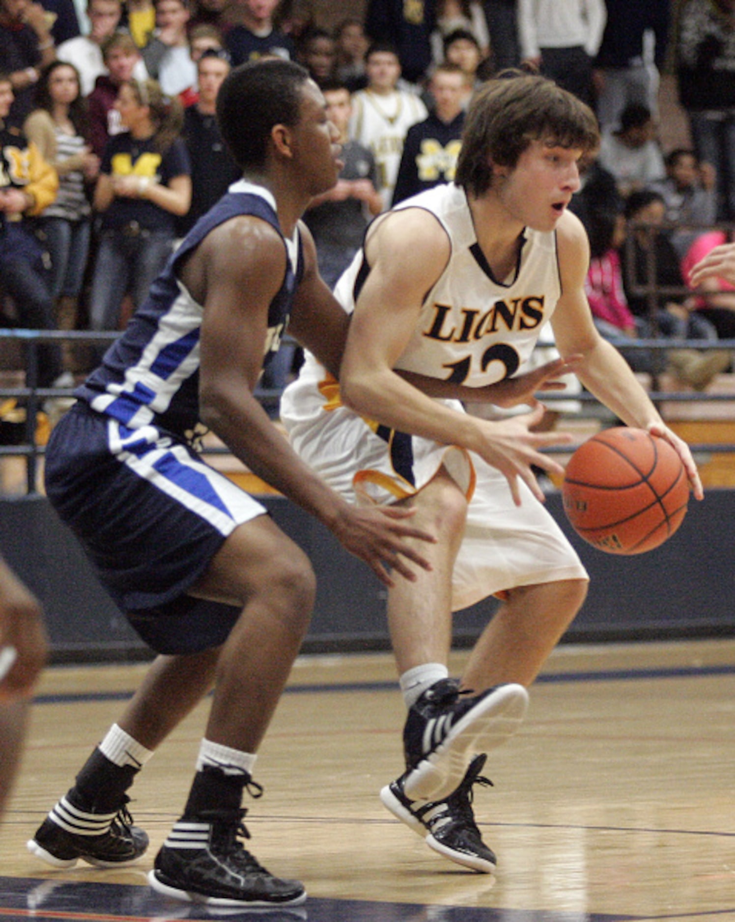 McKinney High School's Tanner Holland (12) is defended by Wylie East High School's Marcell...