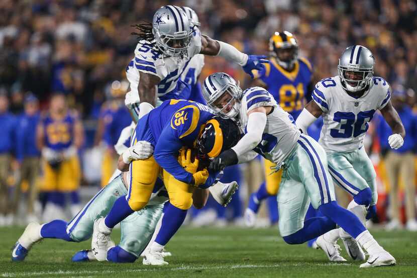 Dallas Cowboys strong safety Jeff Heath (38) works to stop Los Angeles Rams running back...