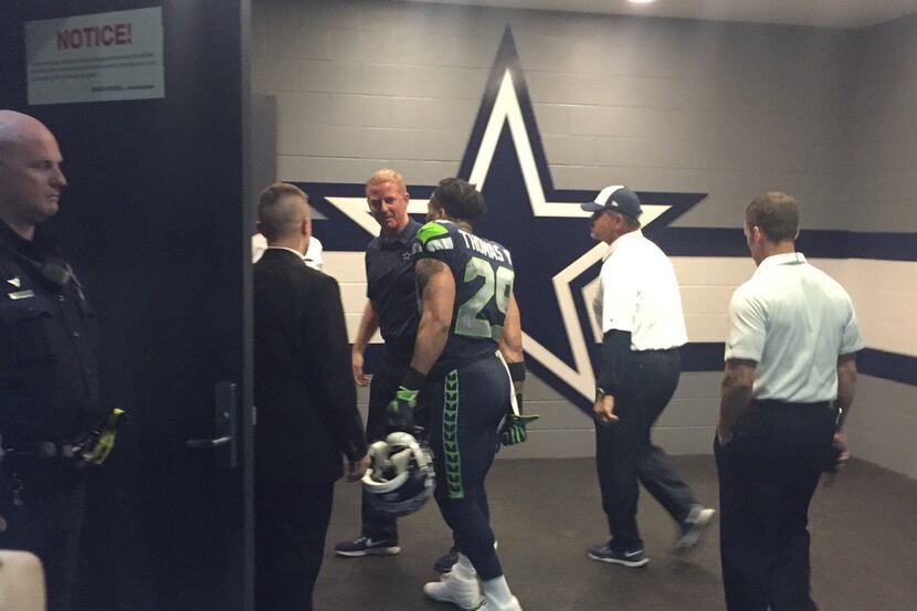 Seahawks safety Earl Thomas talks to Jason Garrett outside the Cowboys locker room after...