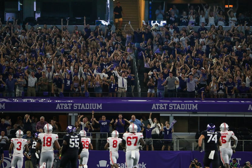 Fans celebrate TCU running back Darius Anderson (6) makes a break for a touchdown during the...