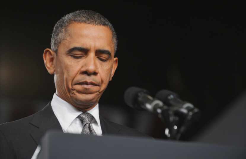 US President Barack Obama pauses as he speaks on the shootings in Aurora, Colorado at what...