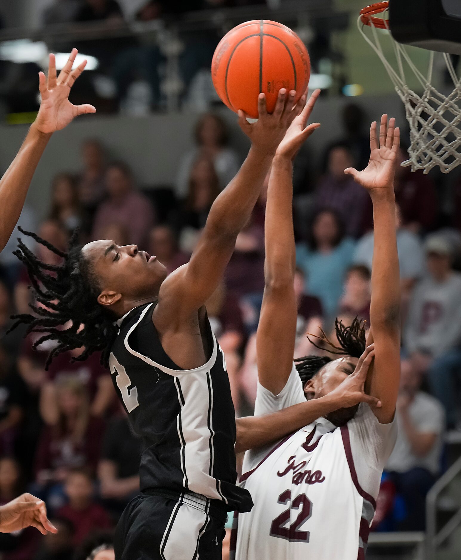 Denton Guyer Jeremiah Green (2) drives to the basket as Plano forward Nikk Williams (22)...