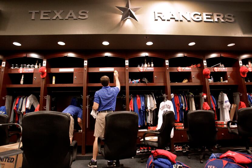 Members of the Texas Rangers clubhouse staff pack up players lockers on Oct. 29, 2011, in...
