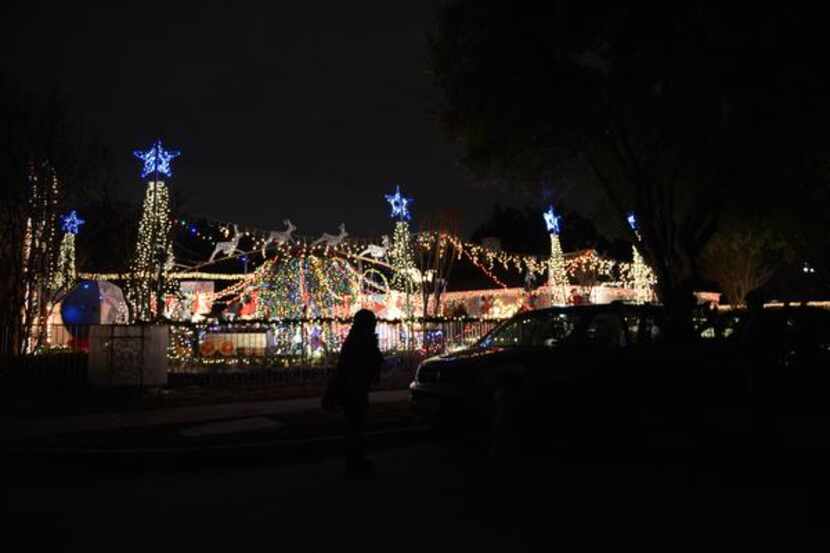 Cars line the street near Joel Occhiuzzo's annual Holiday Express Riding Train in Richardson.