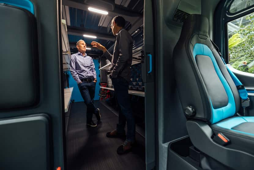 Amazon CEO Andy Jassy (left) with Rivian CEO RJ Scaringe inside a new Rivian electric...